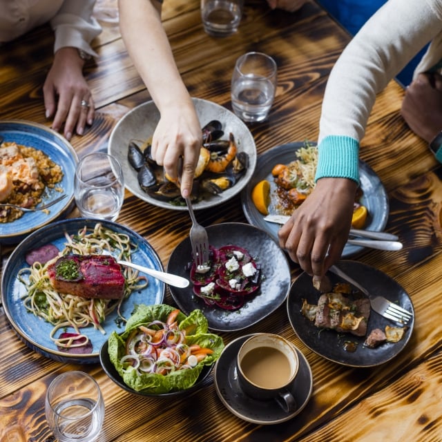 Group of people enjoying lots of food