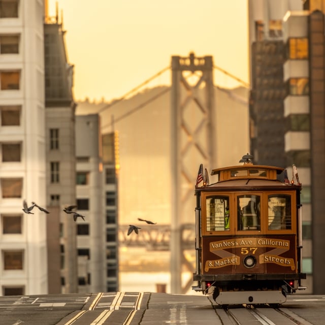 View of the San francisco nob hill cable car with the golden gate bridge in the background