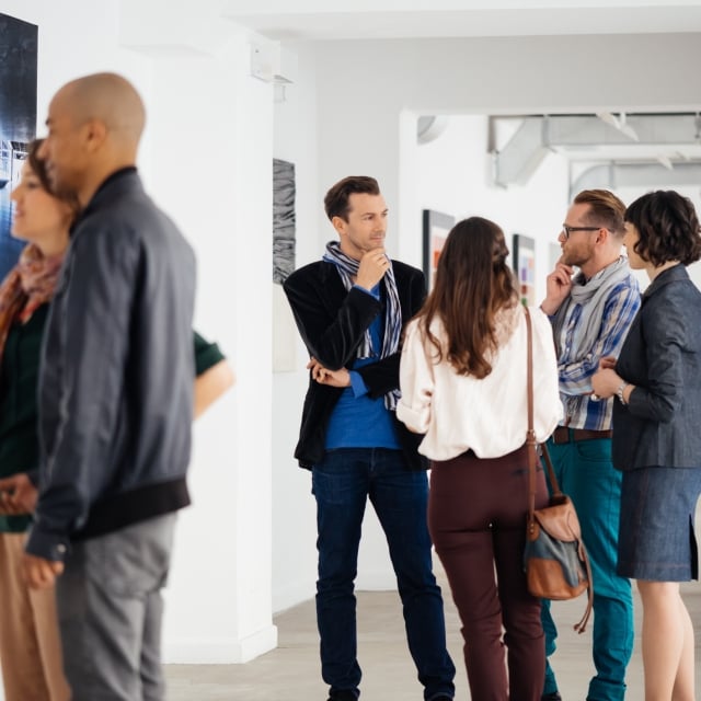 Groups of people looking at art on the walls at the Yerba Buena Center for the arts