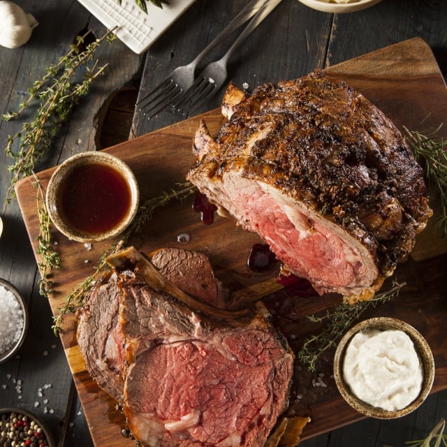 Prime Rib roast sliced up and prepared on a cutting board