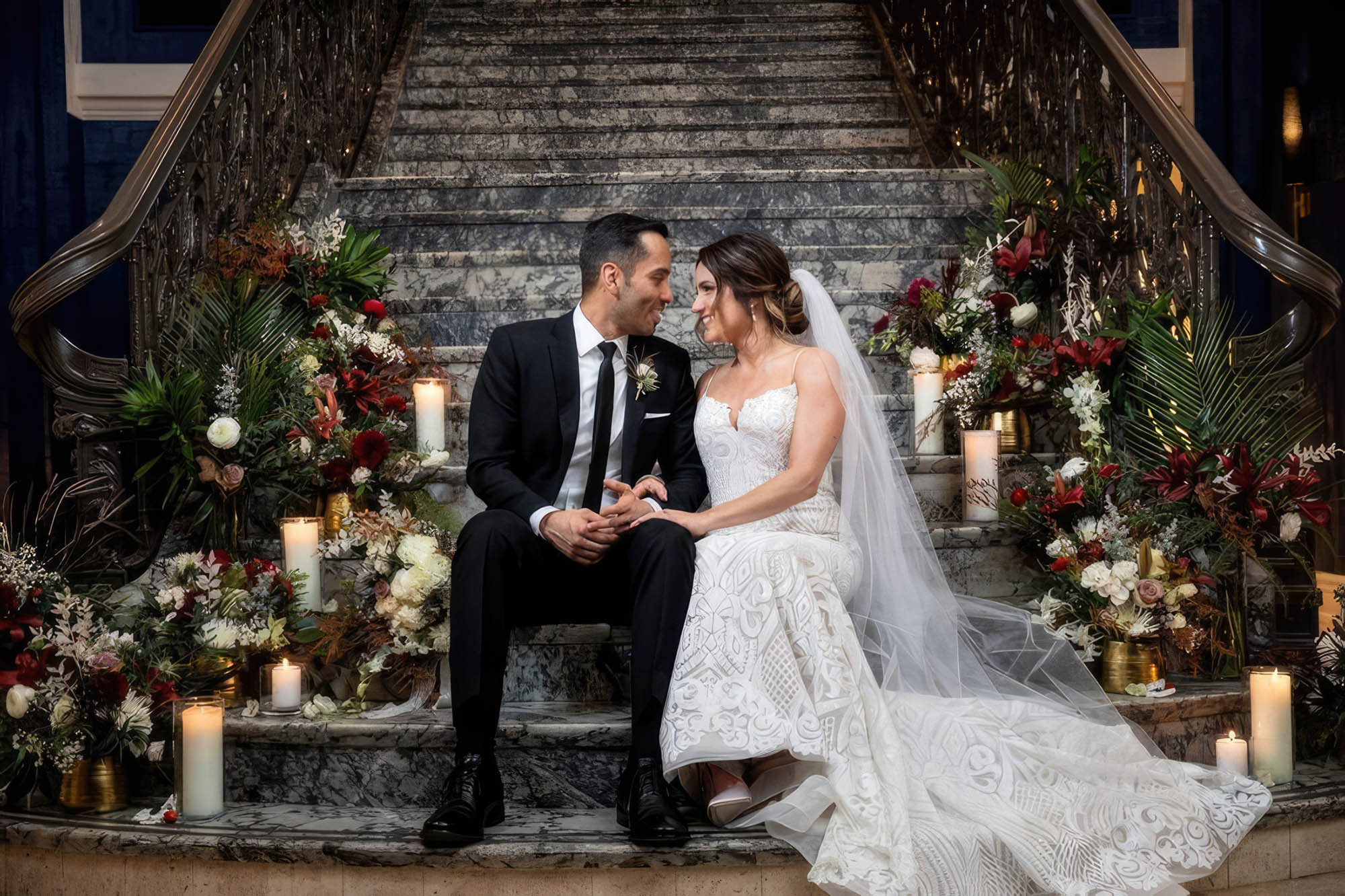 A bride and groom sitting on stairs celebrating their wedding at The Marker